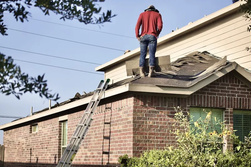 Professional roofer working on a residential roof in Quail Run